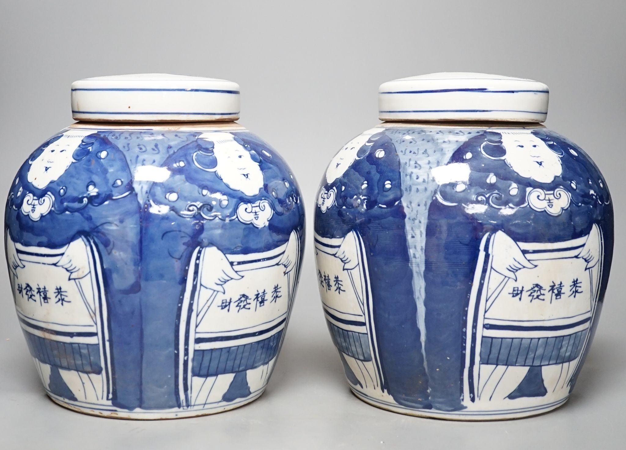 A pair of Chinese blue and white ovoid jars and covers, 25cm